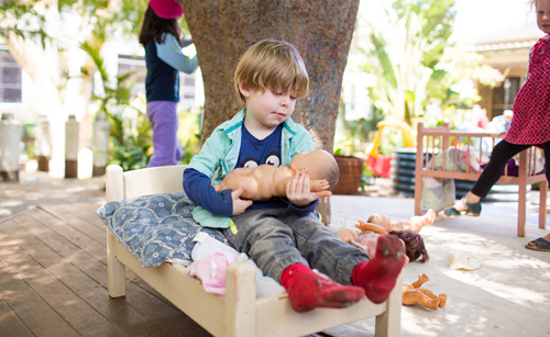 Child playing with doll